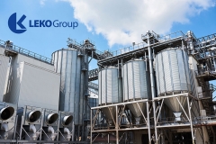 Agricultural Silos. Building Exterior. Storage and drying of grains, wheat, corn, soy, sunflower against the blue sky with white clouds